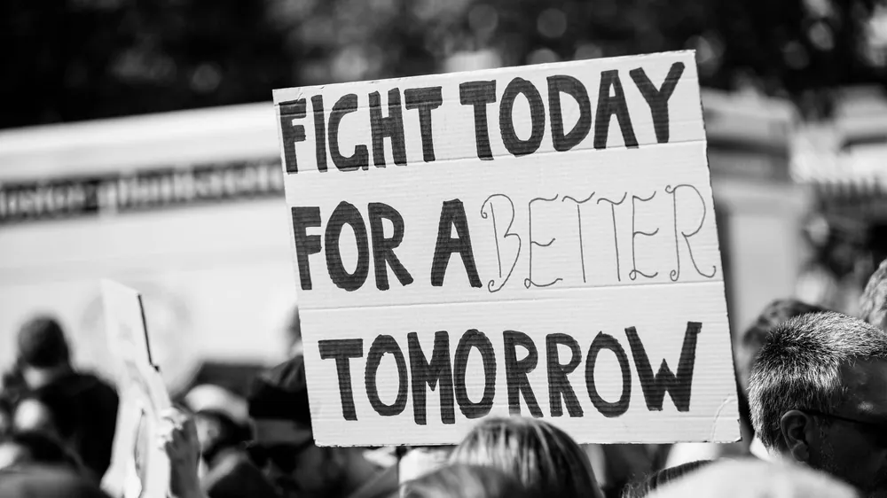 Cardboard sign at a demonstration: Fight today for a better tomorrow.